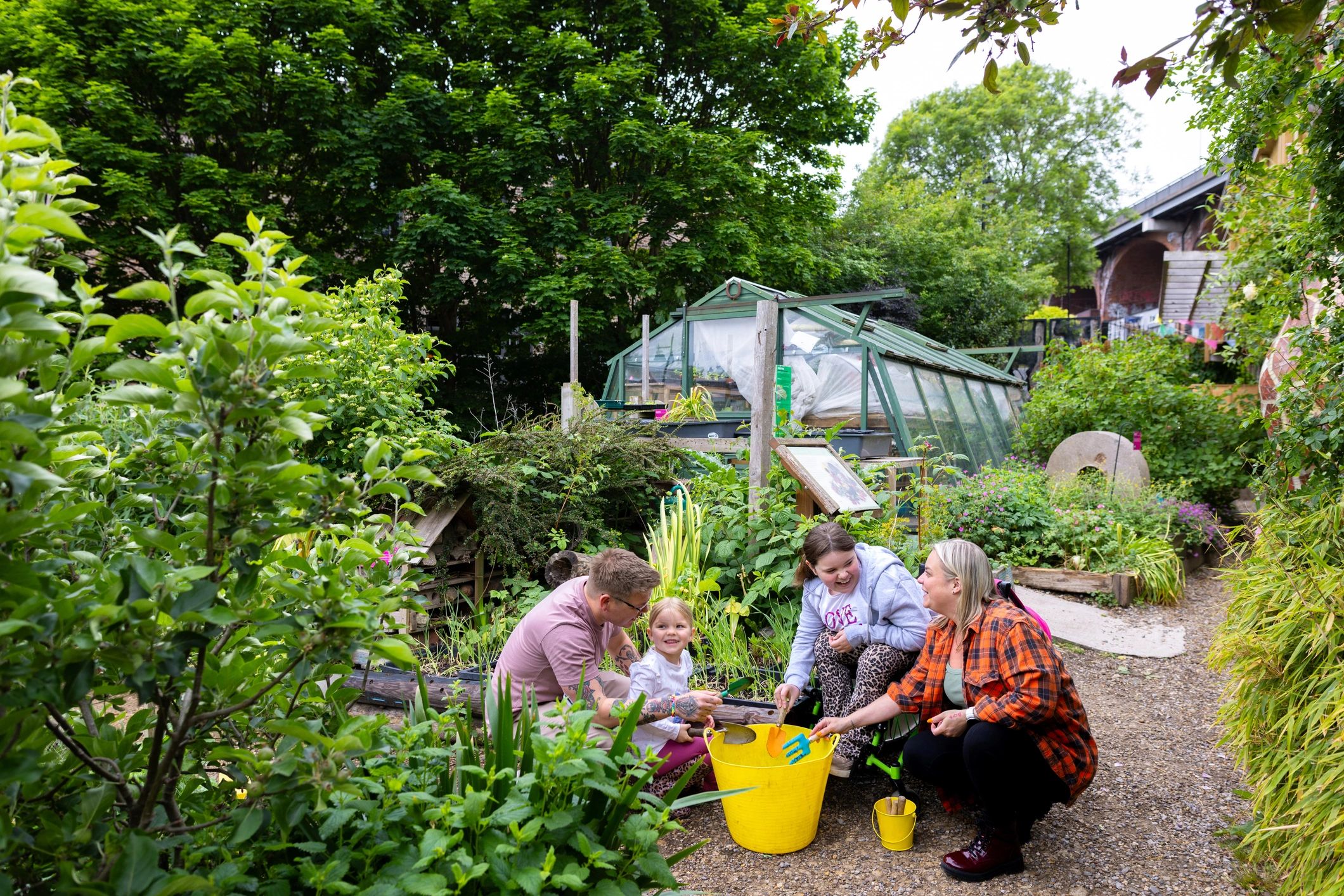 Happy gardening client outdoors in a green setting